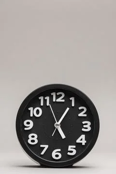 Close up black alarm clock plain background Stock Photos