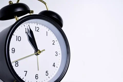 Close up black analog clock on white background Foto stock