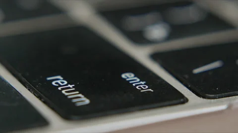 Close up of black and silver keyboard showing enter and return keys for typing Stock Footage 340400917