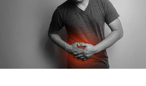 Close up black and white image a man with a gray T-shirt with a hand on his s Stock Photos