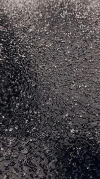 Close-up of black asphalt road surface with rough texture Stock Photos
