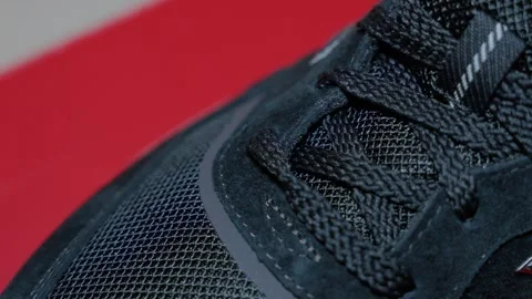 Close-up of black athletic shoe with textured fabric and laces. Detailed Stock Footage 332738245