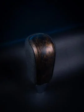 Close-up of a black automatic transmission knob made of leather with a wooden Stock Photos
