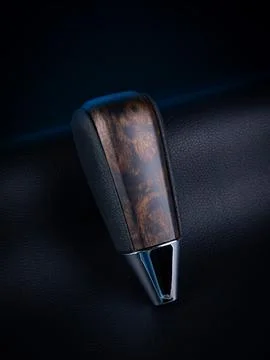 Close-up of a black automatic transmission knob made of leather with a wooden Stock Photos