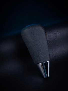 Close-up of a black automatic transmission knob made of leather on a black ba Stock Photos