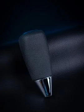 Close-up of a black automatic transmission knob made of leather on a black ba Stock Photos