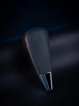 Close-up of a black automatic transmission knob made of leather on a black ba Stock Photos