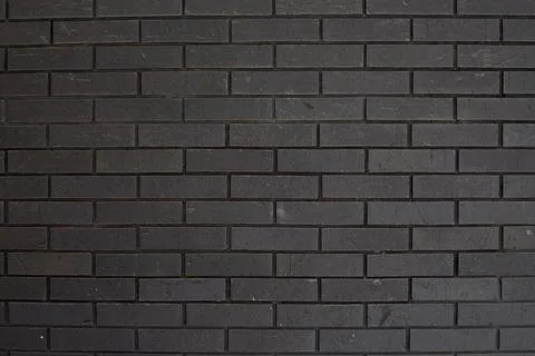 Close up of black brick wall with clean, uniform rectangular bricks. Neutra.. 스톡 사진