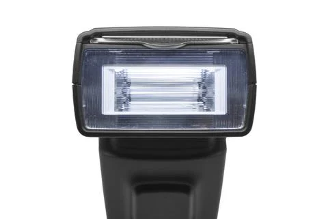 Close-up of a black camera flash speedlight head and textured lens Foto stock