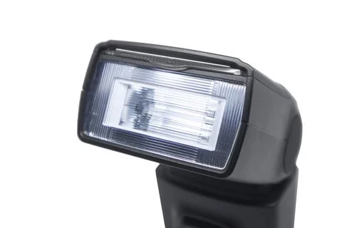 Close-up of a black camera flash speedlight head and textured lens, isolate.. Stock Photos