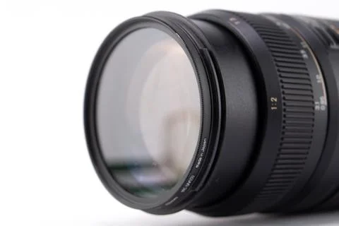 Close-up of a Black Camera Lens with Filter on White Background, Photograph.. Stock Photos