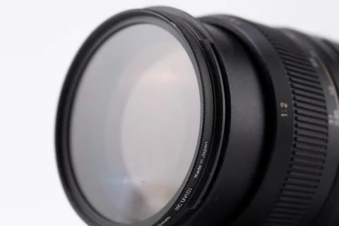 Close-up of a Black Camera Lens with Filter on White Background, Photograph.. Stock Photos