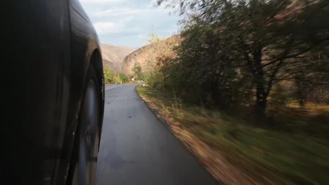 Close up black car Front Right Wheel Of A Car Driving On The Road POV in be.. 動画素材 289896509