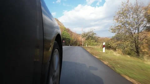 Close up black car Front Right Wheel Of A Car Driving On The Road POV in be.. Stock Footage 290066645