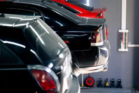 Close-up of a black car without wheels raised at a service station by special Stock Photos