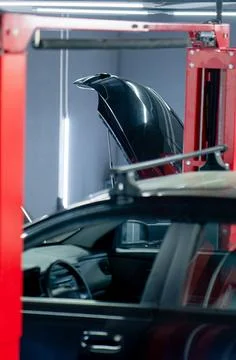 Close-up of a black car without wheels raised at a service station by special Stock Photos