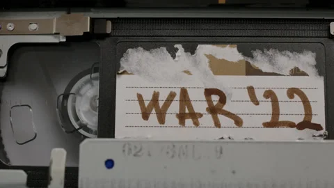 Close up black cassette is inserted into old retro cassette player with Stock Footage 219905618