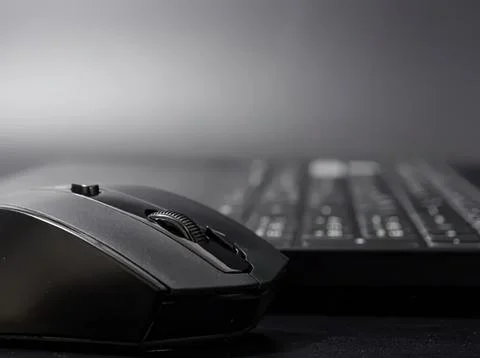 Close-up of black computer mouse and keyboard on desk Stock Photos