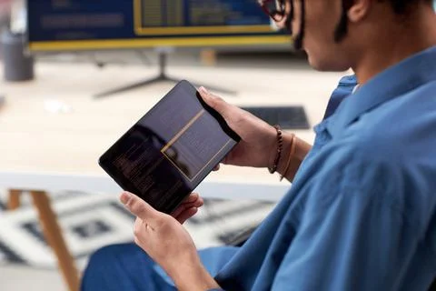 Close up of black computer programmer holding tablet 写真素材