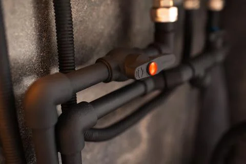 Close-up of black connected polypropylene tap with pipes. Stock Photos