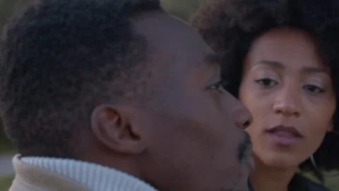 Close up of a black couple talking and smiling together outdoors Stock Footage 339790729