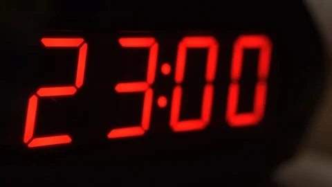 Close-up of black digital clock screen showing 23.00. Modern timer system Stock Footage 121256376