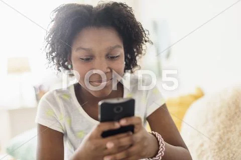 Close Up Of Black Girl Using Cell Phone