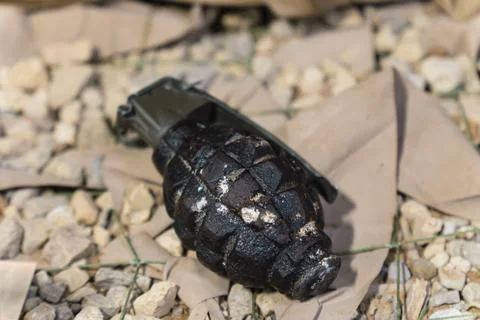 Close up of an black grenade on ground .fragmentation grenade Stock Photos