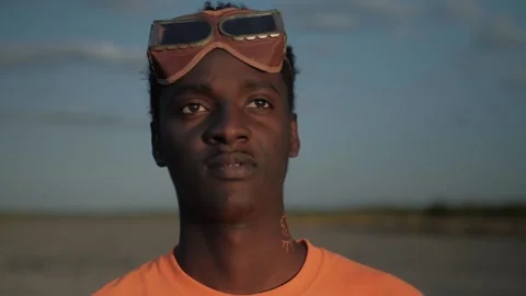 Close up black guy with a glasses looking at the sunset into the distance Stock Footage 137845354