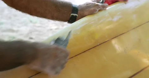 Close-up black hands repairs old yellow surfboard. Stock Footage 155993037