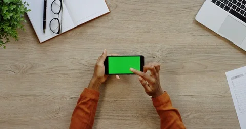 Close up of the black horizontal smartphone being on the light wooden desk of Stock-Footage 96005671