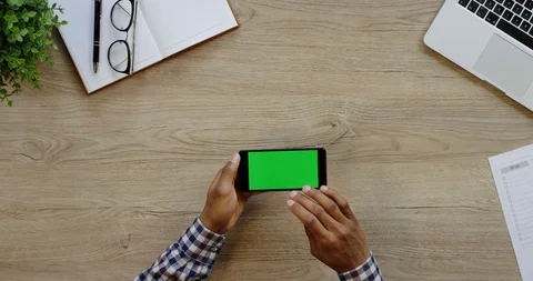Close up of the black horizontal smartphone being on the light wooden desk of Stock-Footage 96007243