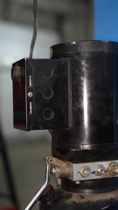Close-up of black industrial machine component with control box and wiring Stock Footage 347642344