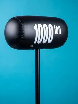 Close up of black inflatable hammer for fun party on blue background Foto stock