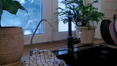 Close up of black kitchen faucet with dripping water. Minimal modern interior, w Stock Footage 329509002