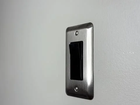 Close-up of a black light switch on a wall Stock Photos