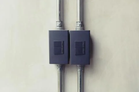 Close up of black lighting switch button on concrete wallpaper background w.. Stock Photos