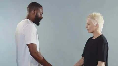 Close up black man and white woman shake hands stop racism all people are equal Stock Footage 133640864