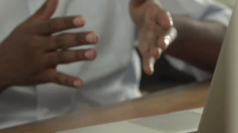 A close-up of a black man conversing via laptop. Stock Footage 44236155