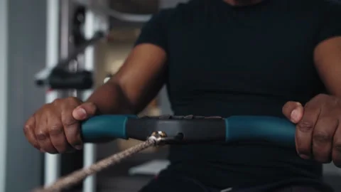 Close-up of Black man do exercises With Rowing Machine in gym.Fitness Young Stock Footage 225717190