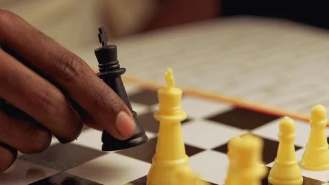 Close up of black man playing chess on a chessboard Selective focus Stock Photos