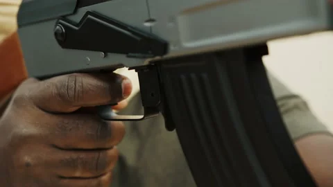 Close up, black man pulling triger on kalashnikov rifle, ak-47 machine gun Video stock 142144449