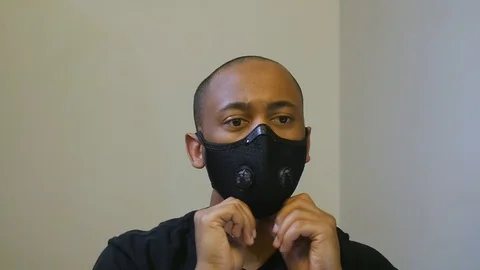 Close up of Black man taking off face mask in slow motion Stock Footage 126798695