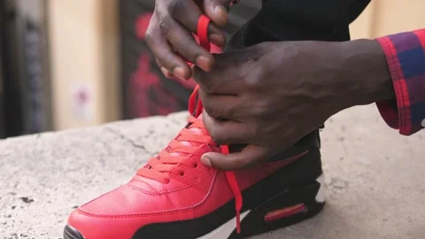 Close up of black man tying red shoe laces Stock-Footage 219624521