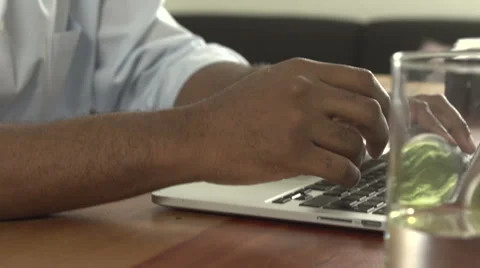 A close-up of a black man typing on a laptop. Stock Footage 44232275