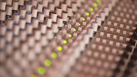 Close-up of Black man's hand adjusting audio mixer knobs on sound console Video stock 331417937