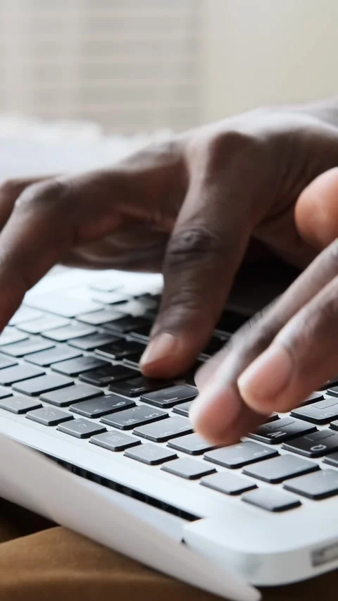 Close-up of a Black Man's Hands Typing on a Laptop Keyboard Stock Footage 326357661
