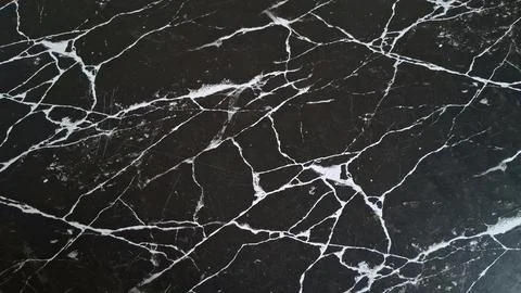 Close-up of black marble surface with white veining. Elegant natural stone Stock Photos