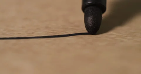 Close-Up of Black Marker Drawing Straight Line on Textured Paper Stock Footage 294262061