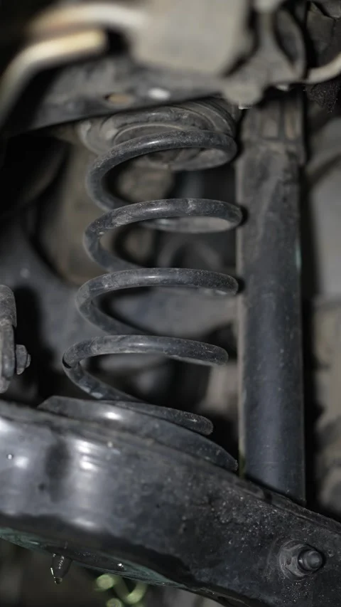Close-up of a black metal coil spring in car suspension. Stock Footage 345707383